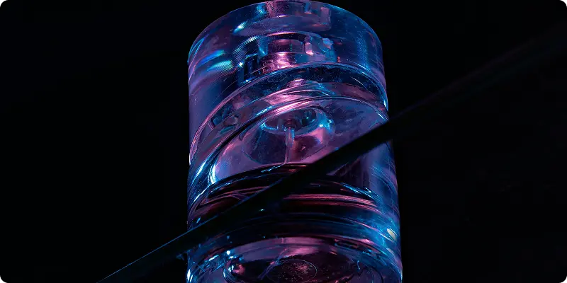 Scientific lab glassware with glowing blue liquid during analysis